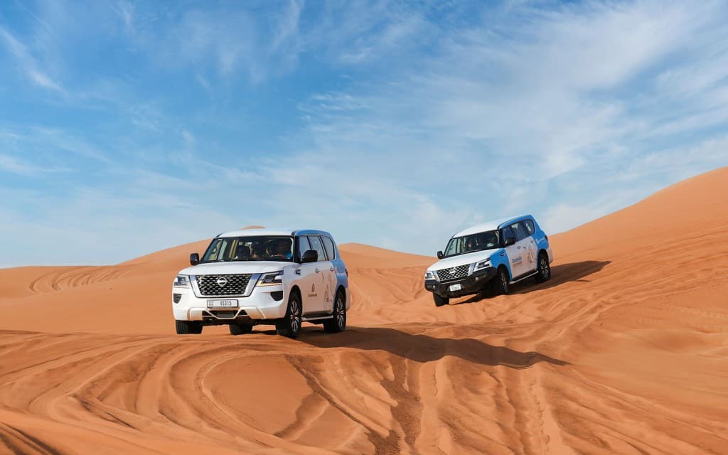 Abu Dhabi Premium Desert Safari with BBQ Dinner, Camel Ride and Sandboarding (Shared Safari)